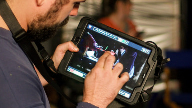 An over-the-shoulder shot of a person using an Onset tablet
