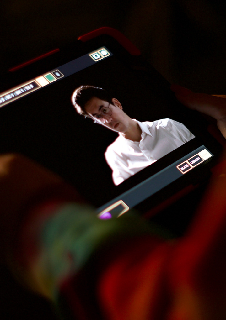 A crew member watching a video with an Onset tablet